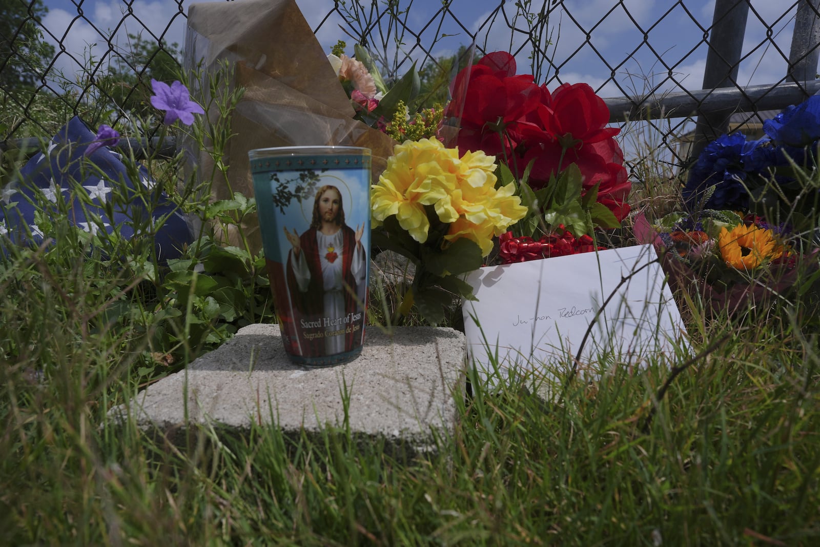 Candles, flowers, and notes make up make-shift memorial for voice actor Jonathan Joss who was recently killed, Tuesday, June 3, 2025, in San Antonio. (AP Photo/Eric Gay)
