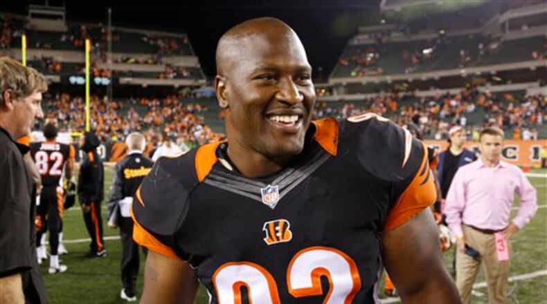 Cincinnati Bengals outside linebacker James Harrison smiles as he leaves the field following their 20-10 win over the Pittsburgh Steelers in an NFL football game, Tuesday, Sept. 17, 2013, in Cincinnati. (AP Photo/David Kohl)