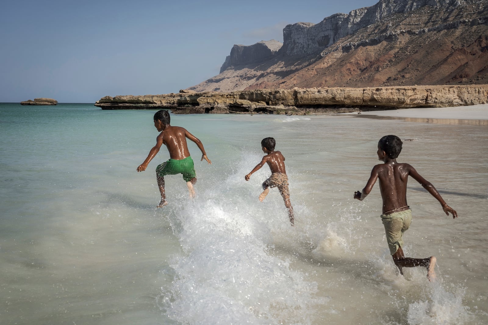 Children play in the waves on the Yemeni island of Socotra on Sept. 22, 2024. (AP Photo/Annika Hammerschlag)
