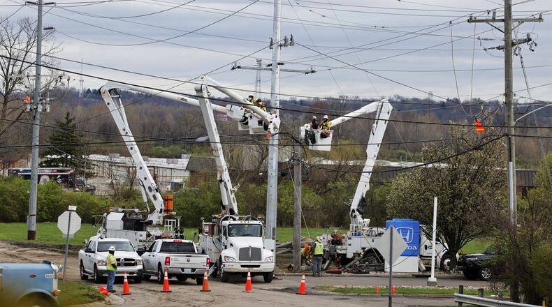 Crews work to replace utility poles Wednesday, April 3, 2024 the day after they fell on I-75 closing both directions of travel. NICK GRAHAM/STAFF
