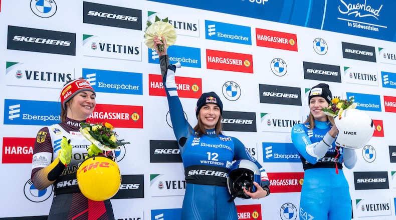 Runner-up Julia Taubitz, of Germany, from left, winner Hannah Prock, of Austria, and third-placed Verena Hofer, of Italy, celebrate on the podium following the Luge Women World Cup, single-seater, 2nd run in Winterberg, Germany, Saturday, Jan. 10, 2026. (David Inderlied/dpa via AP)