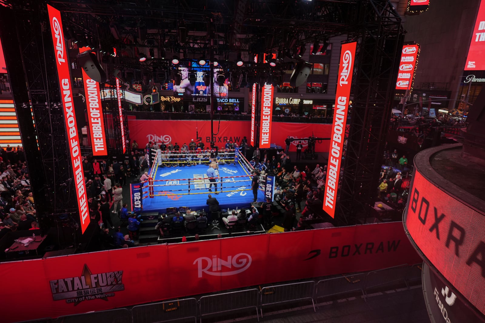 Fans watch Teofimo Lopez and Arnold Barboza Jr. fight during a super lightweight boxing match in Times Square Friday, May 2, 2025, in New York. (AP Photo/Frank Franklin II)