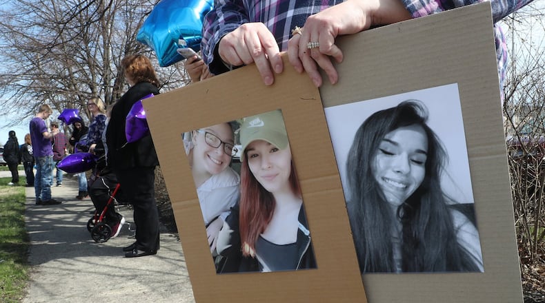 Friends and family of Jacob Smith and Ashlynn Dooley, wait along North Limestone Street for Jacob and Ashlynn’s funeral procession to leave Jackson Lytle and Lewis Life Celebration Center Friday. BILL LACKEY/STAFF