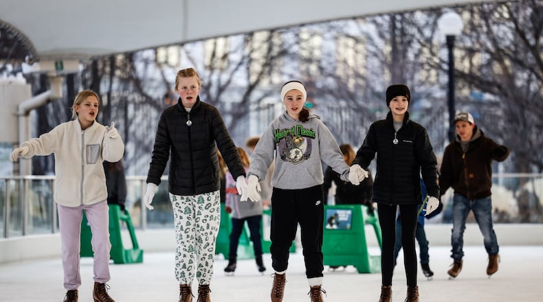 Lots of people are enjoying the warm weather on the first day of winter at RiverScape in Dayton. Jim Noelker/Staff