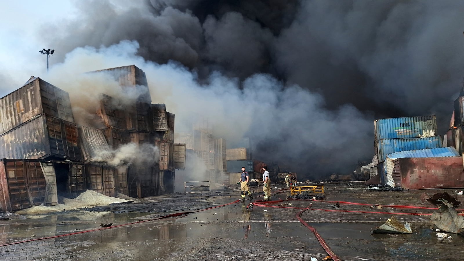 Firefighters work to extinguish the fire, Sunday, April 27, 2025, after a massive explosion and fire rocked a port near the southern port city of Bandar Abbas, Iran on Saturday. (AP Photo/Meysam Mirzadeh/Tasnim News)