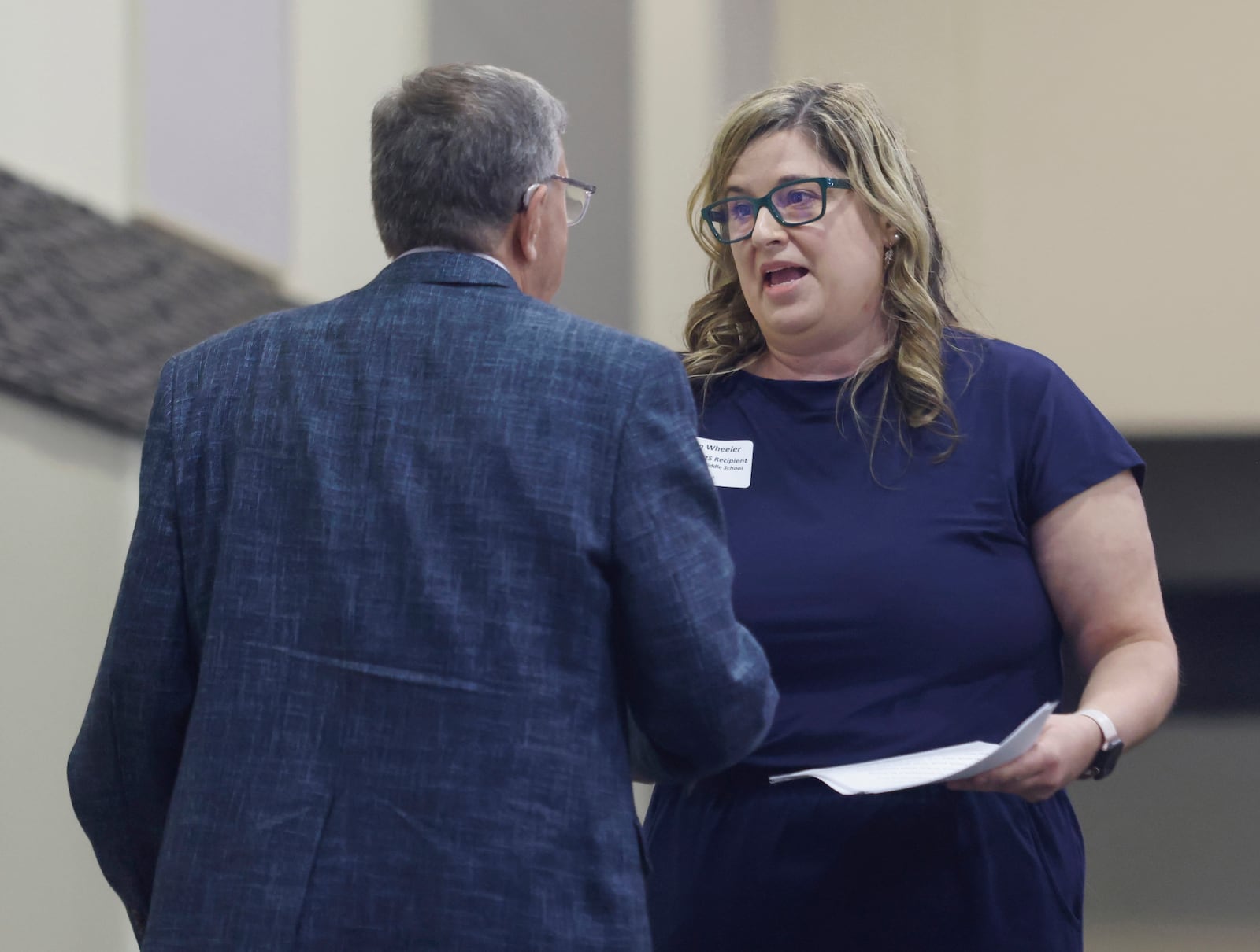 Robyn Wheeler, teacher at Hayward Middle School, greets Ed Leventhal, co-chair of Excellence in Teaching in Springfield Rotary, after she speaks at the Excellence in Teaching Awards Luncheon during Springfield Rotary Club's meeting on Monday, April 21, 2025, at the Hollenbeck Bayley Center. JOSEPH COOKE/STAFF