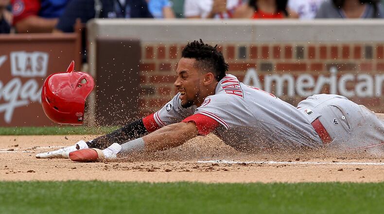 CHICAGO, IL - JULY 5:  Billy Hamilton #6 of the Cincinnati Reds slides into home plate to score a run in the first inning against the Chicago Cubs at Wrigley Field on July 5, 2016 in Chicago, Illinois. (Photo by Dylan Buell/Getty Images)