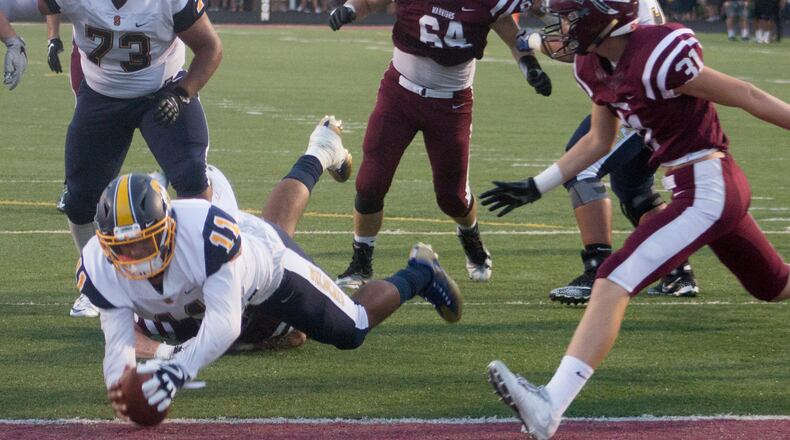 Springfield quarterback Leonard Taylor scores on an 8-yard run in the first quarter to tie the score 7-7 at Lebanon on Friday night. Jeff Gilbert/CONTRIBUTED