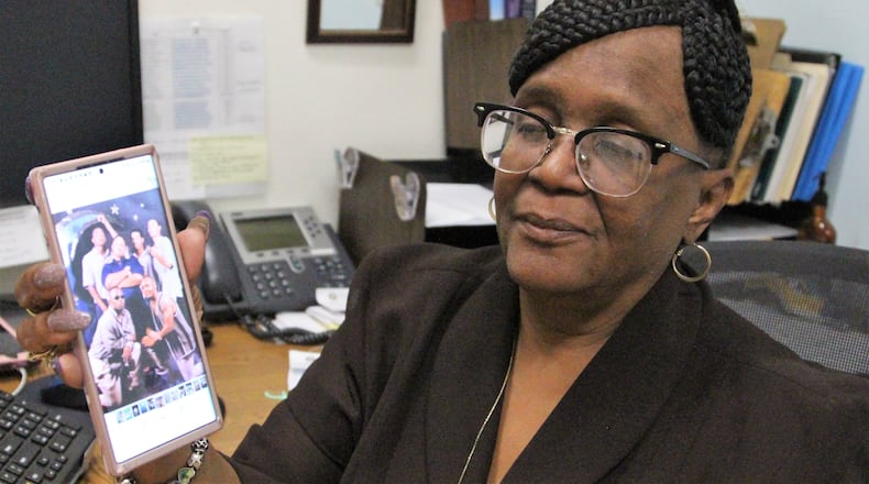 Victoria Arnold holds up a picture on her phone of her late son Titus' childhood friends who she refers to as the "Fab 9." That includes Deputy Matthew Yates, who was killed in the line of duty on Sunday. Arnold has known Yates since he was 7-years-old. Hasan Karim/Staff