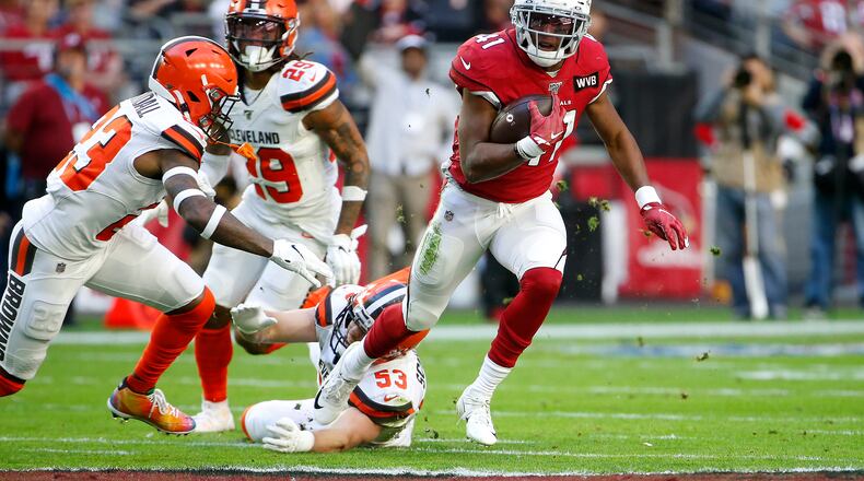 GLENDALE, ARIZONA - DECEMBER 15: Running back Kenyan Drake #41 of the Arizona Cardinals eludes the tackle of Joe Schobert #53 of the Cleveland Browns as safety Damarious Randall #23 of the Browns closes in during the first half of the NFL football game at State Farm Stadium on December 15, 2019 in Glendale, Arizona. (Photo by Ralph Freso/Getty Images)