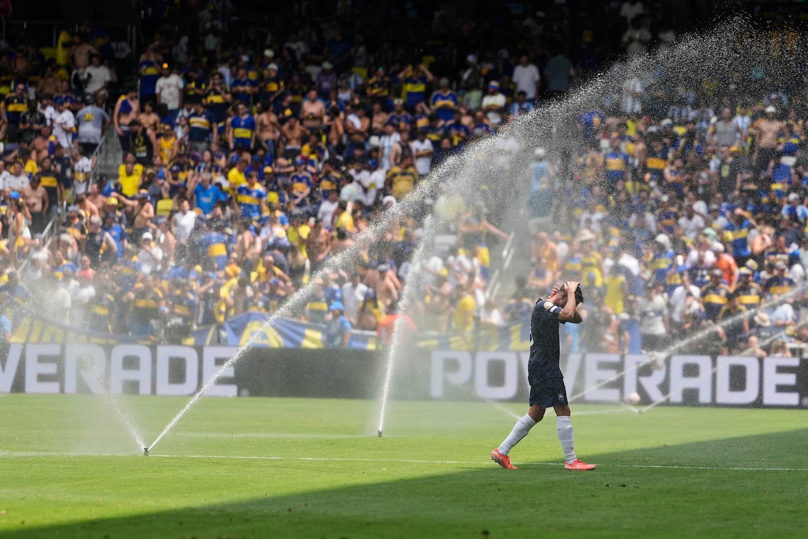 FILE - Auckland City's Gerard Garriga cools off under the sprinklers during a water break in the Club World Cup Group C soccer match between Auckland City and Boca Juniors in Nashville, Tenn., Tuesday, June 24, 2025. (AP Photo/George Walker IV, File)