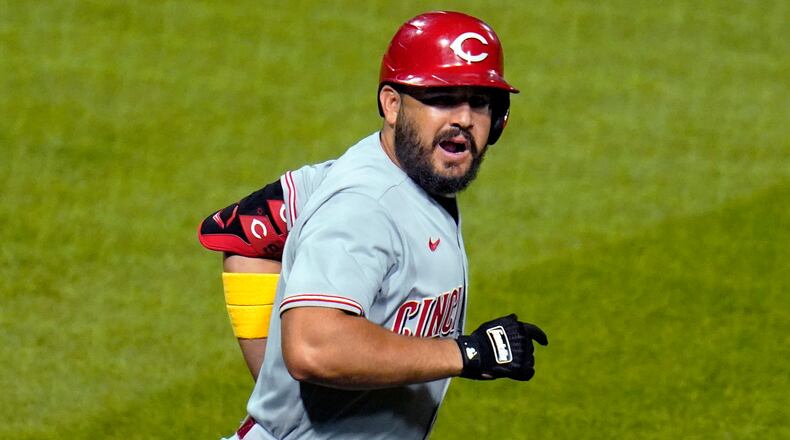 Cincinnati Reds' Eugenio Suarez celebrates as rounds first base after hitting a three-run home run off Pittsburgh Pirates starting pitcher Trevor Williams during the third inning of a baseball game in Pittsburgh, Saturday, Sept. 5, 2020. It was the first of two homers in the game for Suarez off Williams. (AP Photo/Gene J. Puskar)
