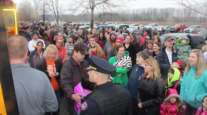 Parents wait for their children to get of buses at Lions Park in West Liberty after a shooting at West Liberty-Salem High School in January. JEFF GUERINI/STAFF