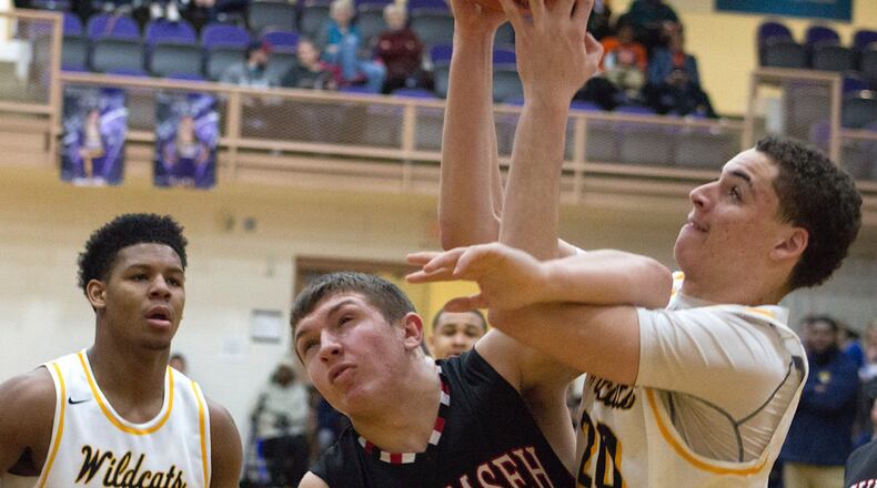 Springfield’s Ani Elliot (right) gets tangled with Tecumseh’s Davey Berner during Saturday’s first-round Division I sectional game at Vandalia-Butler. Springfield won 65-26 and will face Troy in the second round at 6 p.m. Thursday. Jeff Gilbert/CONTRIBUTED