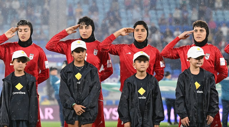Iran players salute during their national anthem ahead of the Women's Asian Cup soccer match between Iran and the Philippines in Robina, Australia, Sunday, March 8, 2026. (Dave Hunt/AAP Image via AP)