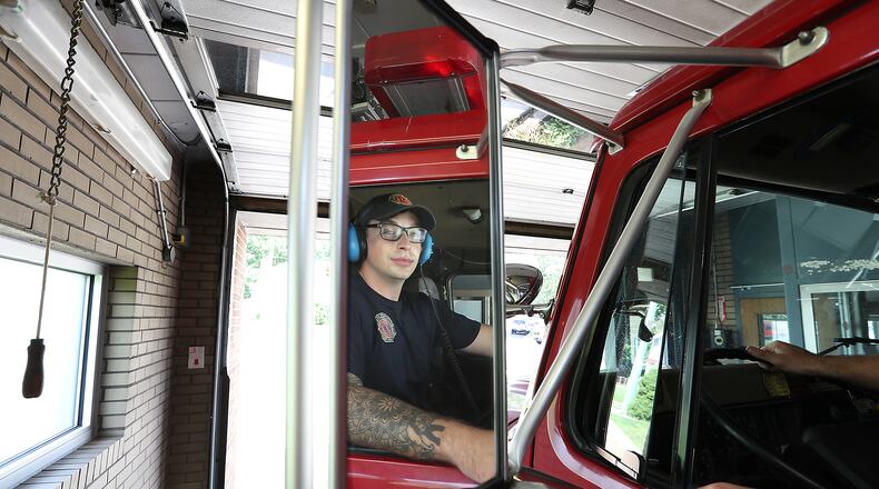 Springfield fire fighter Skyler Baise checks his mirrors as he backs the fire engine into the tiny garage bay at Fire Station #3. That station could be replaced as the city looks to build three new fire stations. BILL LACKEY/STAFF