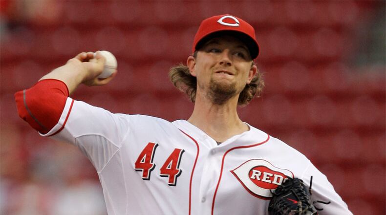 Cincinnati Reds starting pitcher Mike Leake throws against the Chicago Cubs in the first inning of a baseball game, Tuesday, Sept. 13, 2011 in Cincinnati.