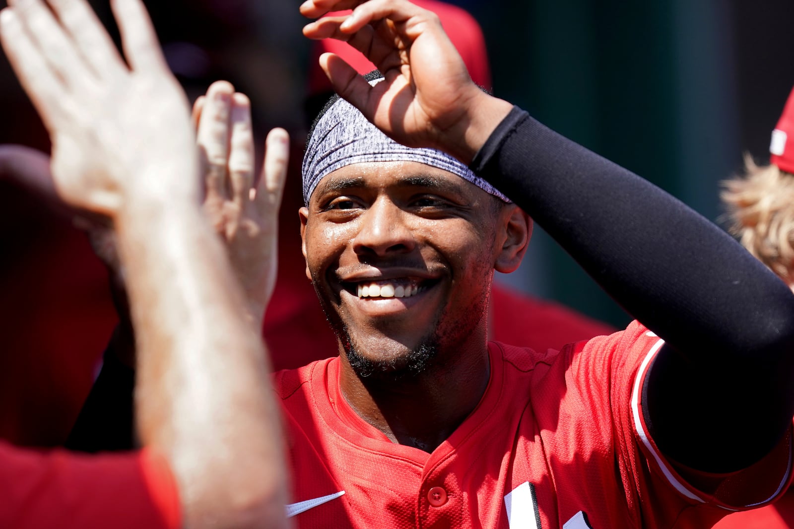 Cincinnati Reds' Ke'Bryan Hayes celebrates in the dugout after scoring during the third inning of a baseball game against the Pittsburgh Pirates, Sunday, Aug. 10, 2025, in Pittsburgh. (AP Photo/Matt Freed)