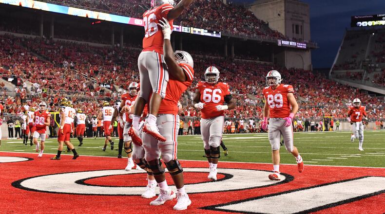 COLUMBUS, OH - OCTOBER 7: Antonio Williams #26 of the Ohio State Buckeyes celebrates in the end zone with Thayer Munford #75 of the Ohio State Buckeyes after scoring on an eight-yard touchdown run in the fourth quarter against the Maryland Terrapins at Ohio Stadium on October 7, 2017 in Columbus, Ohio. Ohio State defeated Maryland 62.14. (Photo by Jamie Sabau/Getty Images)