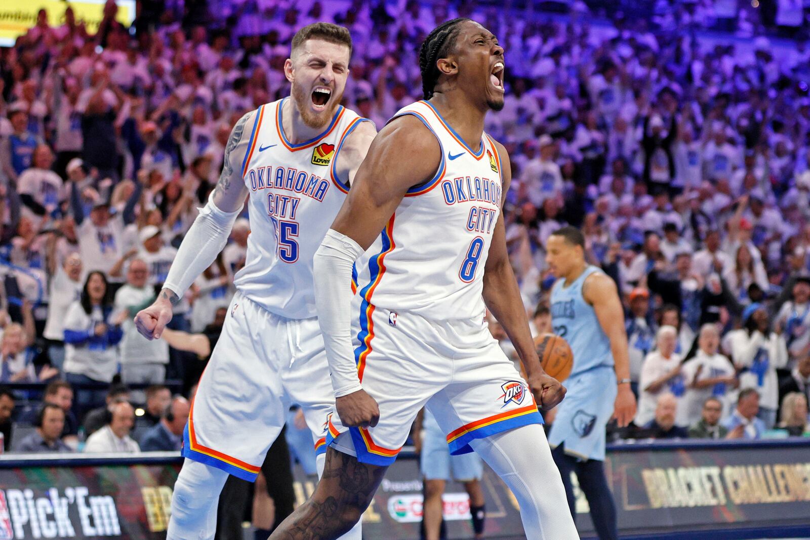 Oklahoma City Thunder center Isaiah Hartenstein, left, and forward Jalen Williams (8) react after a dunk by Williams during the first half in Game 1 of an NBA first-round playoff series against the Memphis Grizzles, Sunday, April 20, 2025, in Oklahoma City. (AP Photo/Nate Billings)