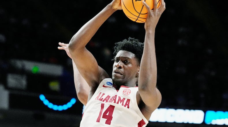 FILE - Alabama center Charles Bediako (14) pulls down a rebound while guarded by Maryland guard Ian Martinez, left, during the second half of a second-round college basketball game in the men's NCAA Tournament in Birmingham, Ala., March 18, 2023. (AP Photo/Rogelio V. Solis, File)