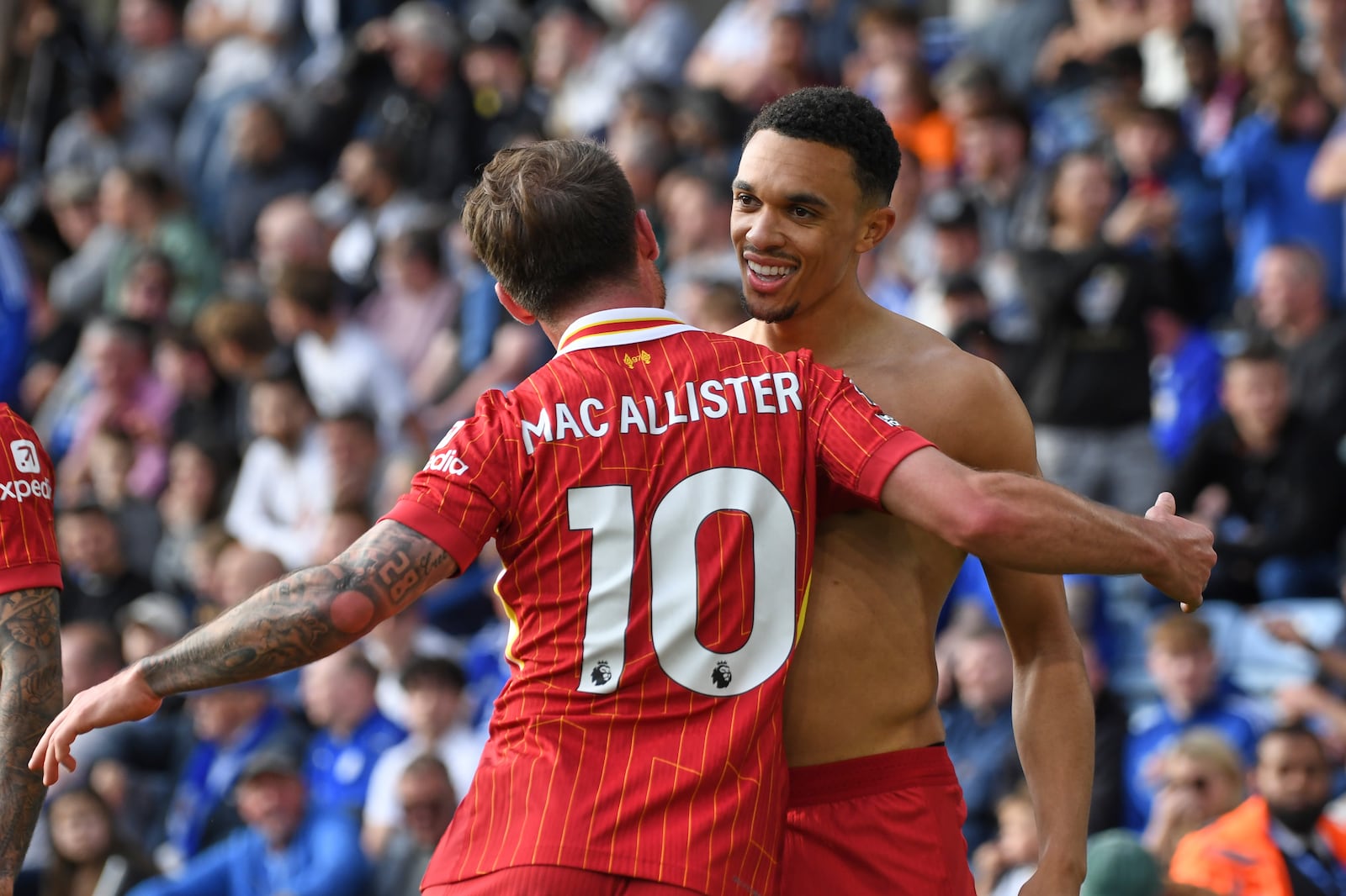 Liverpool's Trent Alexander-Arnold, right, celebrates with Liverpool's Alexis Mac Allister after scoring his side's opening goal during the English Premier League soccer match between Leicester City and Liverpool at King Power stadium in Leicester, England, Sunday, April 20, 2025. (AP Photo/Rui Vieira)