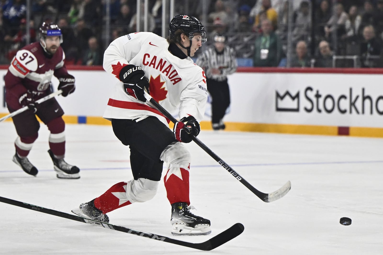 Canada's Kent Johnson scores his side's fourth goal during the IIHF Ice Hockey World Championship group A match between Latvia and Canada at Avicii Arena in Stockholm, Sweden, Sunday, May 11, 2025. (Christine Olsson/TT News Agency via AP)