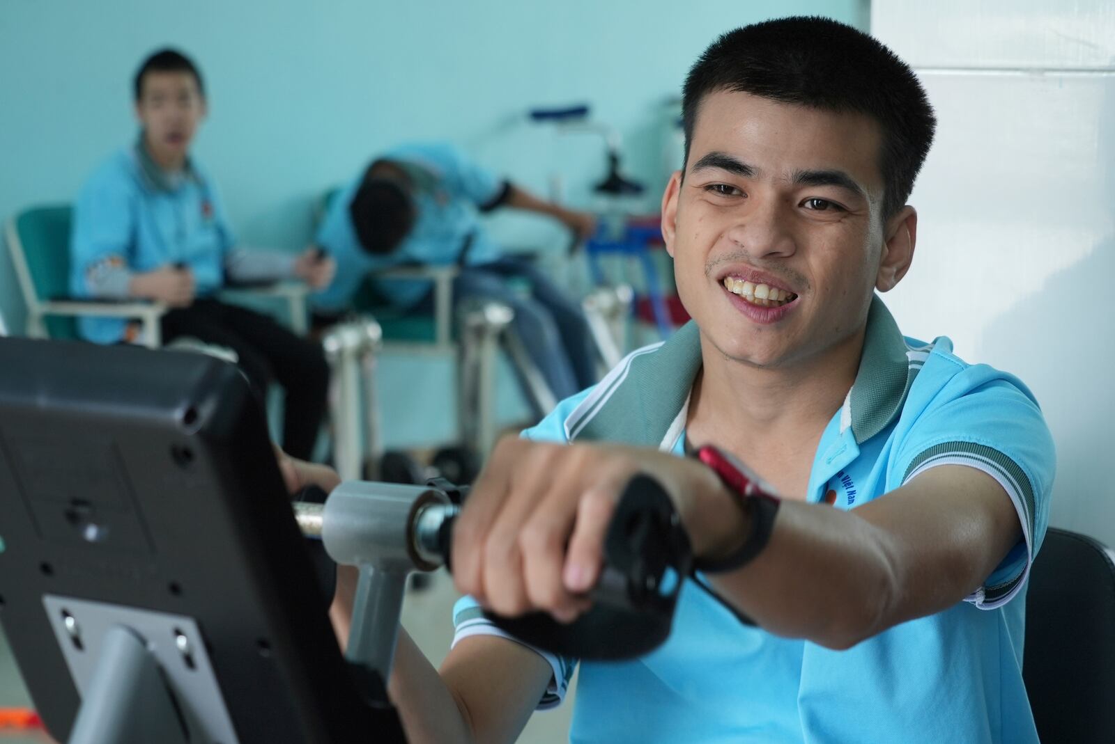 Truong Minh Phu, 20, practices with an arm pedal exerciser in physiotherapy class at a school for victims of Agent Orange in Da Nang, Vietnam, March 7, 2025. (AP Photo/Hau Dinh)