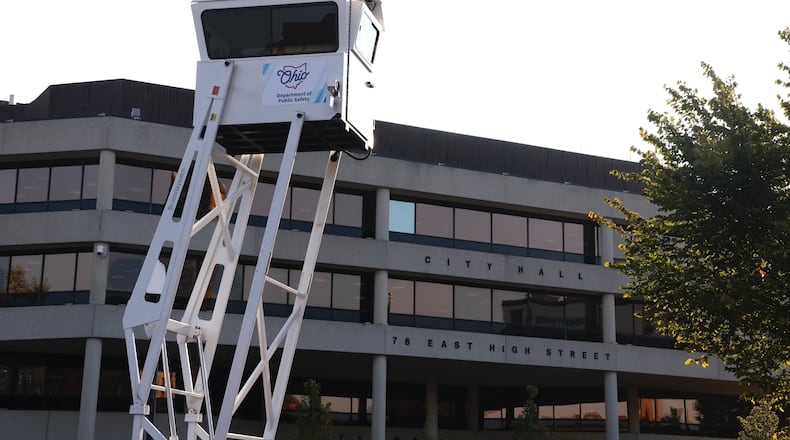 An Ohio Department of Public Safety surveillance tower rises over the parking lot across the street from Springfield City Hall on the morning of Monday, Sept. 16, 2024. BILL LACKEY / STAFF