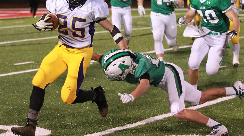 Chayse Propst of Mechanicsburg (with ball) eludes Isaac Lininger of Anna. Anna defeated Mechanicsburg 36-6 in a Division VI high school football state semifinal at Wapakoneta’s Harmon Field on Friday, Nov. 29, 2019. MARC PENDLETON / STAFF