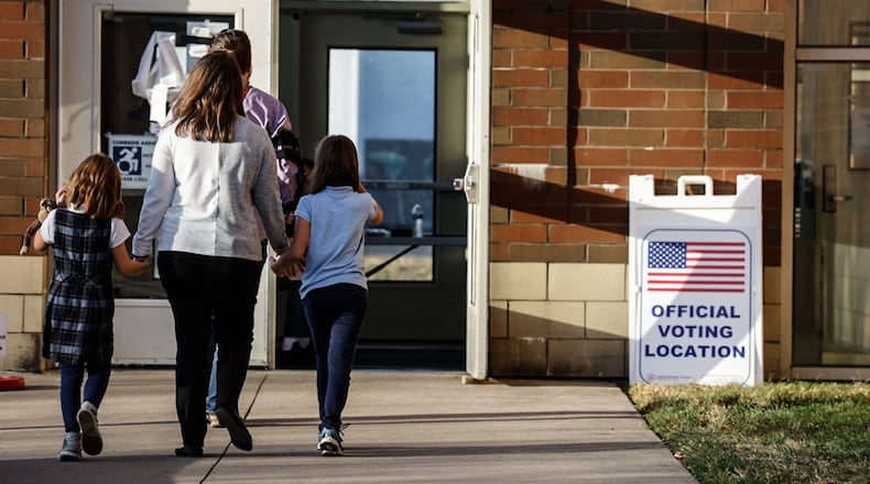 A family goes to vote at Stivers School for the Arts in the November 2024 election. Jim Noelker/Staff