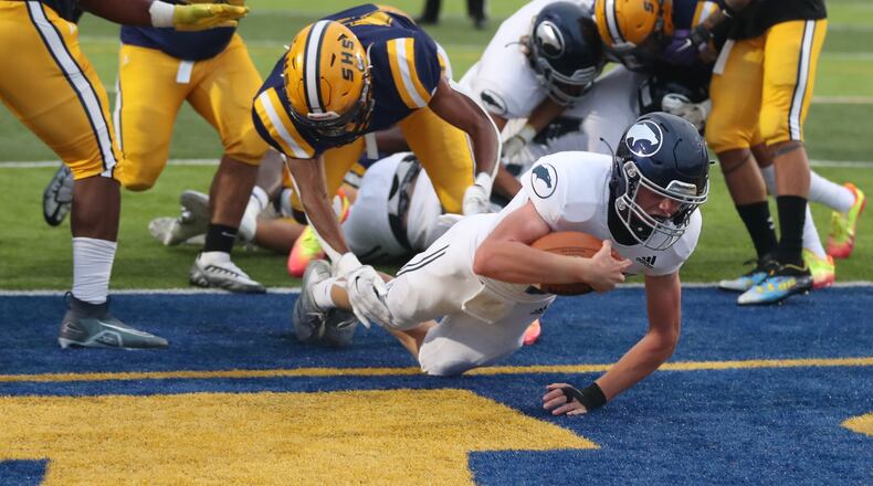 Fairmont quarterback, Brock Baker, dives into the end zone for a Fairmont touchdown against Springfield during Friday’s game. BILL LACKEY/STAFF