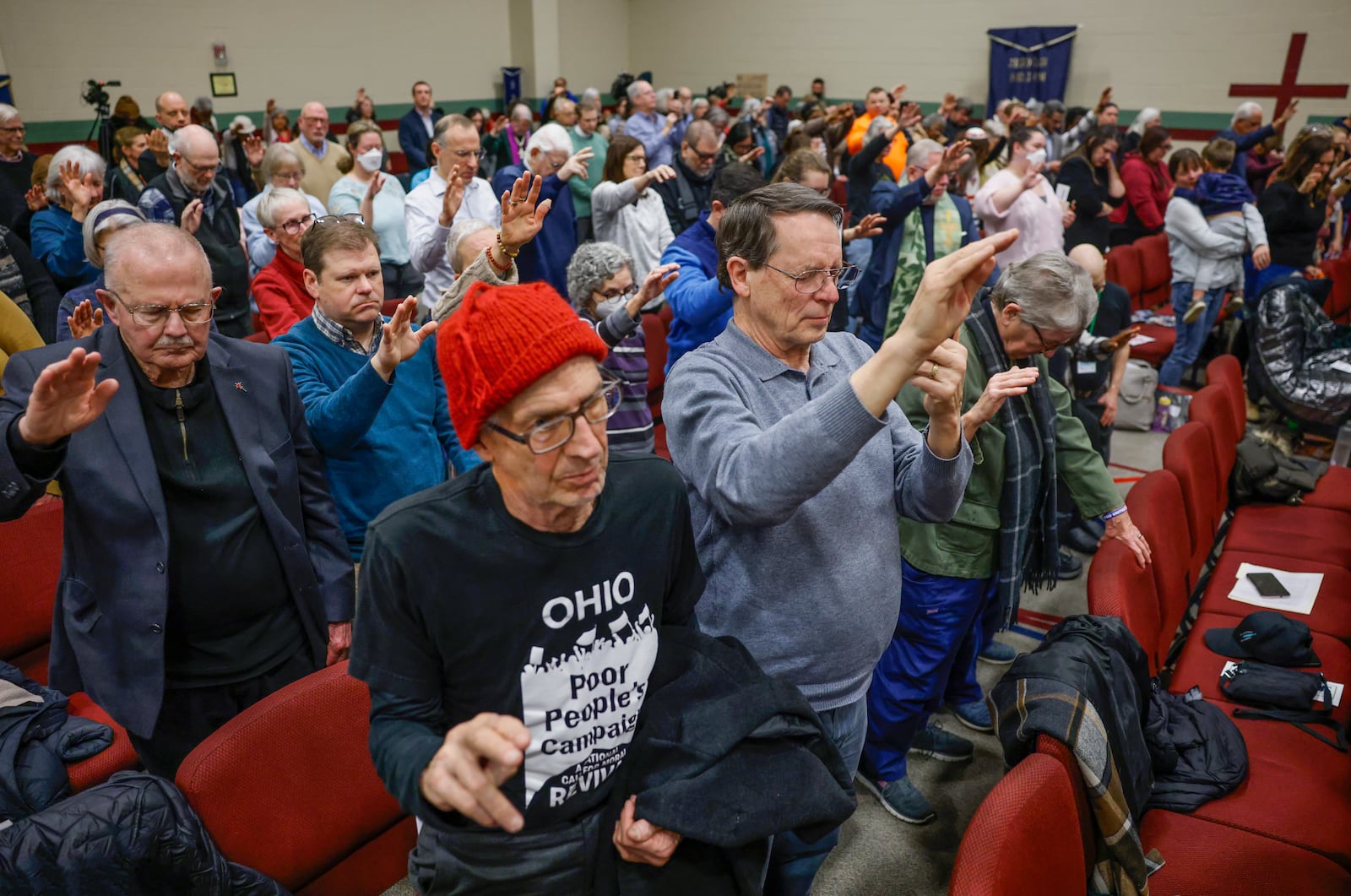 Audience members hold their hands up in prayer during Here We Stand: Faith Leaders for Immigration Justice & Family Unity at St. John Missionary Baptist Church on Monday, Feb. 2, 2026, in Springfield. Pastors, faith leaders and community members gathered to pray and call for the extension of Temporary Protected Status, which is scheduled to expire on Tuesday, Feb. 3, 2026. JOSEPH COOKE/STAFF