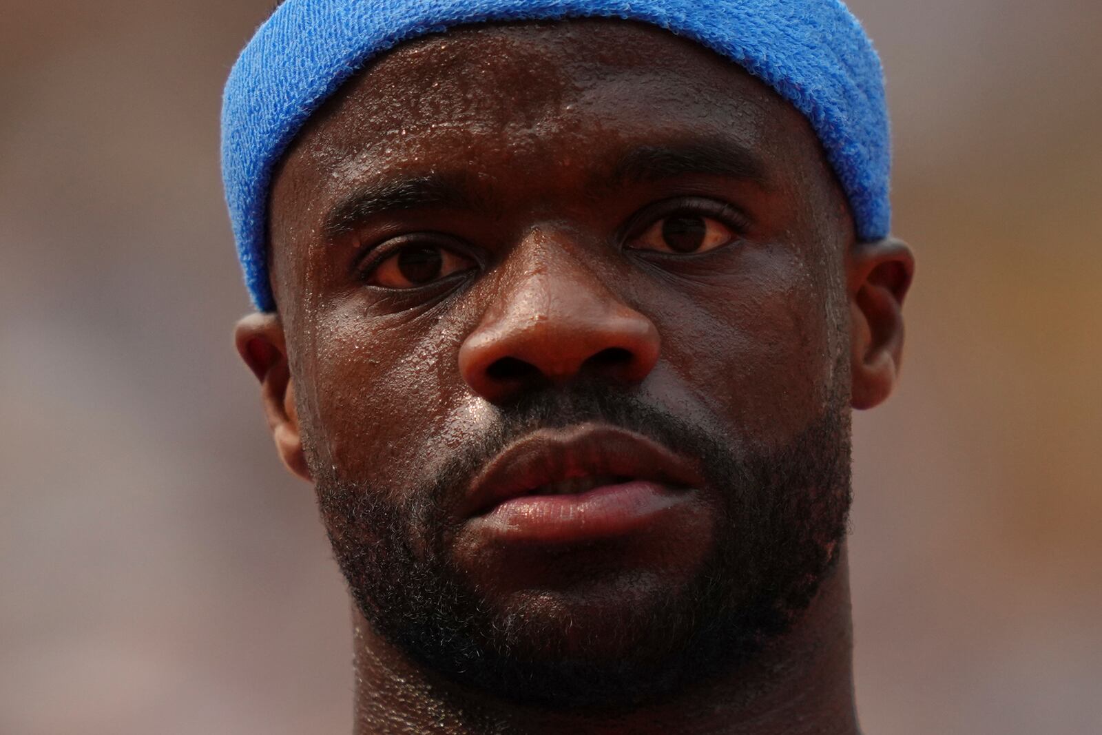 Frances Tiafoe of the U.S. reacts as he plays against Italy's Lorenzo Musetti during their quarterfinal match of the French Tennis Open at the Roland-Garros stadium in Paris, Tuesday, June 3, 2025. (AP Photo/Aurelien Morissard)