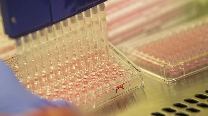 A pipette is used to transfer the flu virus at the University of Georgia College of Veterinary Medicine building in Athens. (ALYSSA POINTER / ALYSSA.POINTER@AJC.COM)