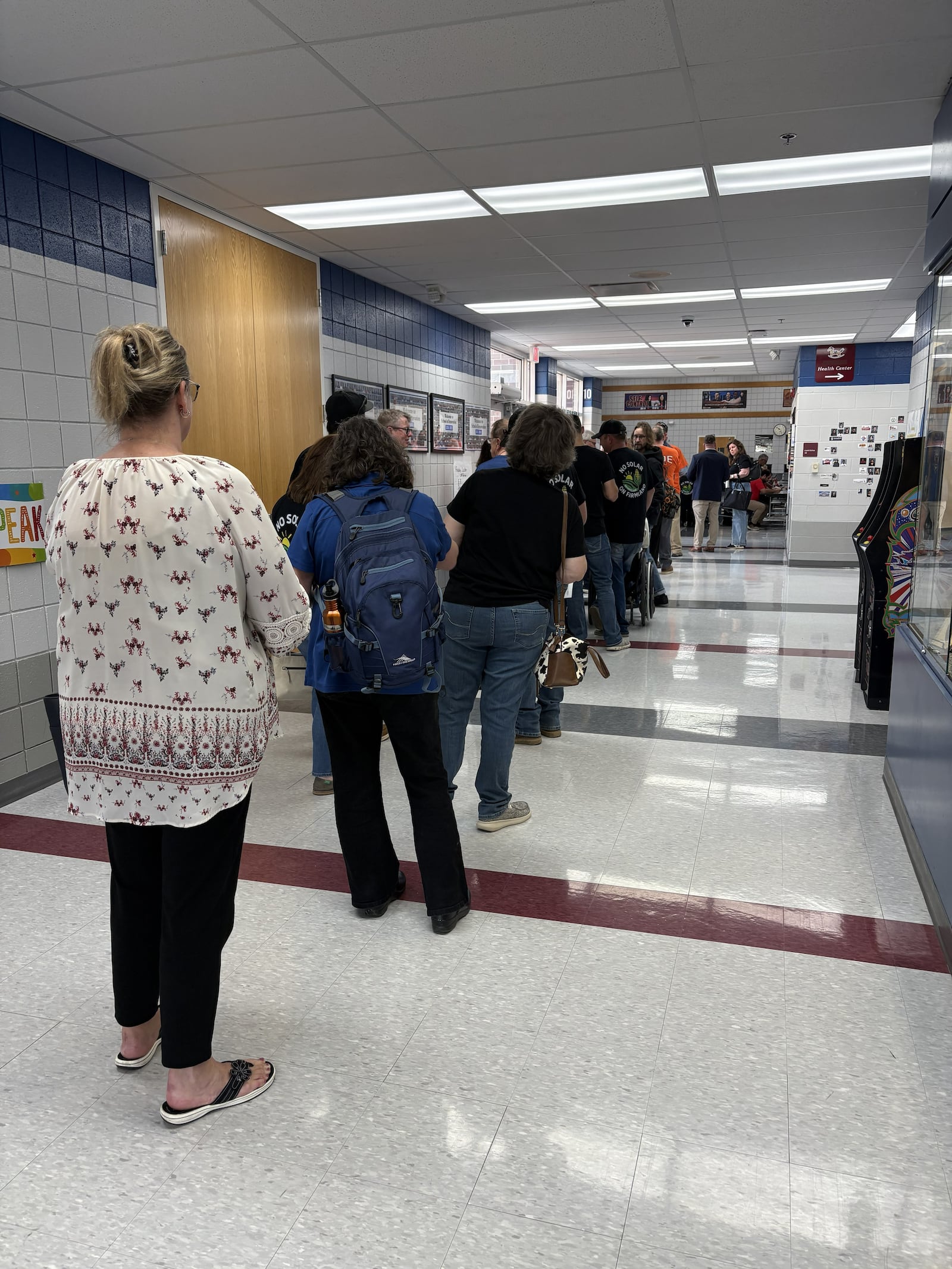 Community members wait in line to sign up to give testimony during the Ohio Power Siting Board's local public hearing March 26, 2026, regarding Sloopy Solar Energy, LLC’s proposal to construct a 180-megawatt solar-powered electric generation facility in Clark County. BROOKE SPURLOCK / CONTRIBUTED