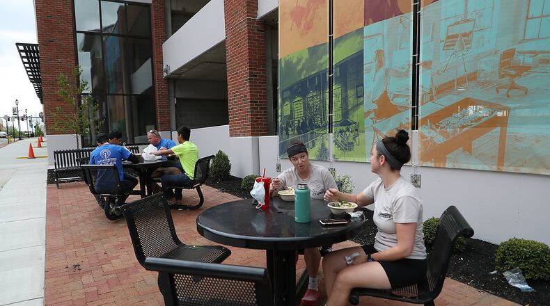 Lisa Freeman, left, and Kelly Hemmann enjoy lunch at one the outdoor dinning spots along Fountain Avenue that were created with the new parking garage. BILL LACKEY/STAFF