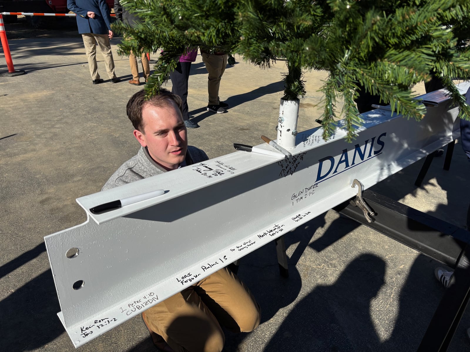Kyle Brewer from Cedarville's Advancement Department adds his name to the beam that will be placed on the Bolthouse Academic Center. Contributed