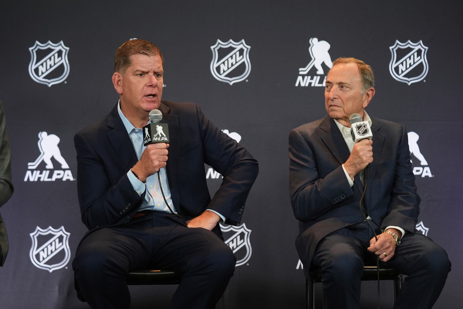 Marty Walsh, left, NHLPA Executive Director, and Gary Bettman, NHL Commissioner, conduct a joint press conference before the NHL hockey draft Friday, June 27, 2025, in Los Angeles. (AP Photo/Damian Dovarganes)