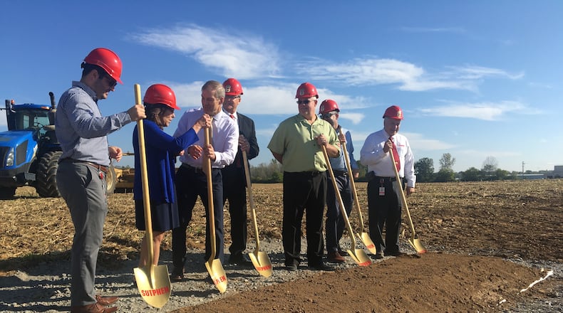 Representatives of Sutphen Corp., join local leaders during a ground breaking ceremony in Urbana on Wednesday. The company that manufactures fire apparatuses plans to start construction on a new $15 million facility in November. Hasan Karim/Staff