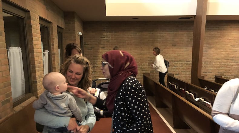 Samina Ahmed, right, of Masjid Al-Madina Mosque greets a Central Christian Church member in this file photo. Ahmed will be a featured speaker at Global Education and Peace Network’s March speaker series on Thursday via Zoom. Photo by Brett Turner