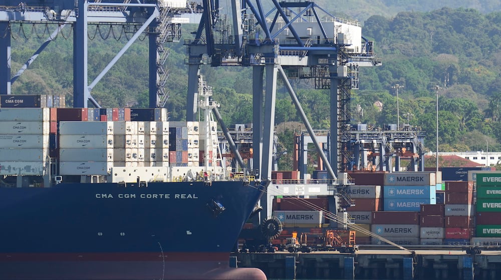 Cranes load a cargo ship at Panama Canal's Port of Balboa, managed by CK Hutchison Holdings, in Panama City, Friday, Jan. 30, 2026. (AP Photo/Matias Delacroix)