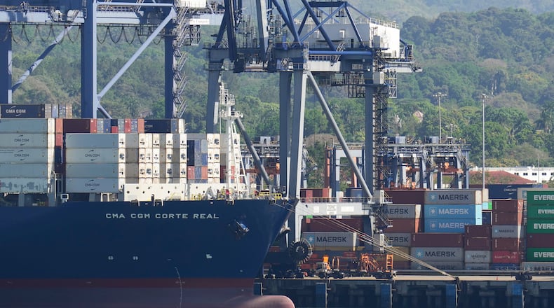Cranes load a cargo ship at Panama Canal's Port of Balboa, managed by CK Hutchison Holdings, in Panama City, Friday, Jan. 30, 2026. (AP Photo/Matias Delacroix)