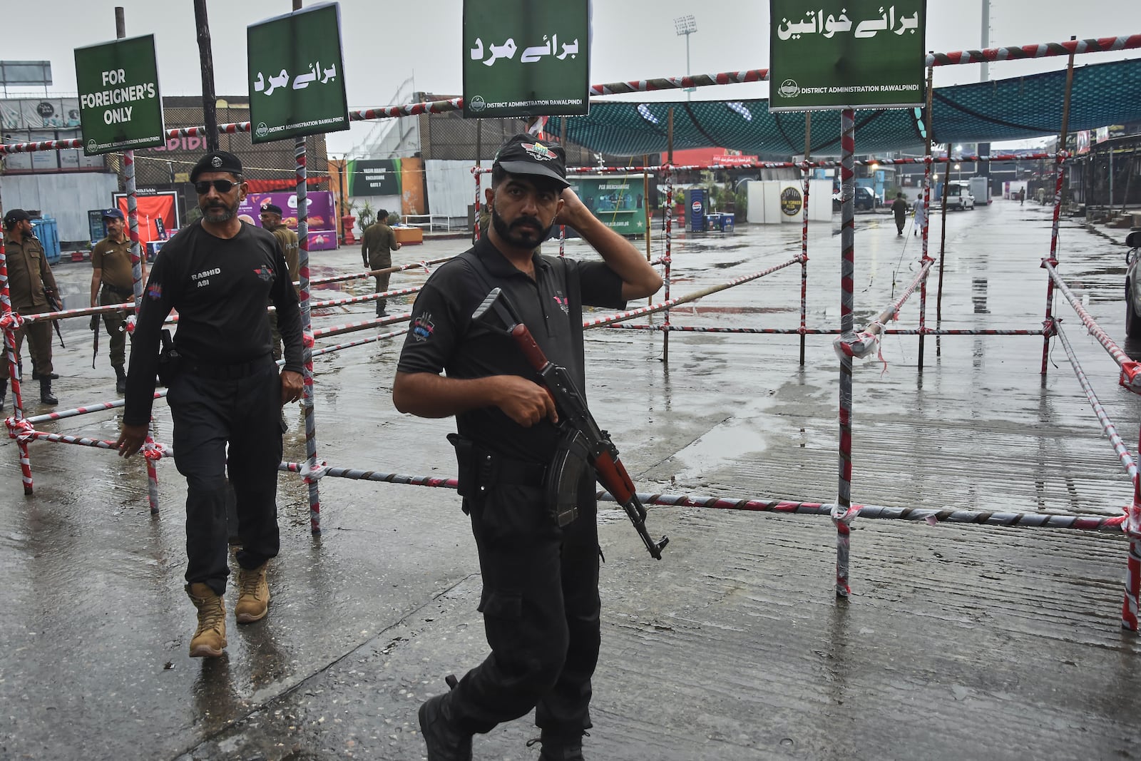 Police officers stand guard at an entry point to Pindi Cricket Stadium following a suspected Indian drones crashed in the parking area, in Rawalpindi, Pakistan, Thursday, May 8, 2025. (AP Photo/W.K. Youszai)