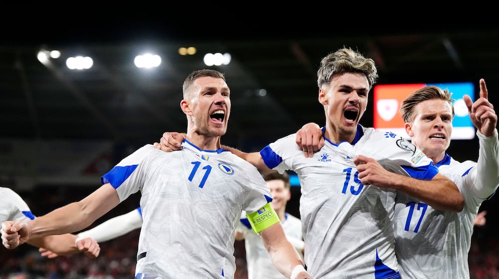 Bosnia and Herzegovina's Edin Dzeko, left, celebrates with team-mates after scoring their side's first goal during the World Cup playoff semifinal soccer match between Wales and Bosnia and Herzegovina in Cardiff, Wales, Thursday, March 26, 2026. (Nick Potts/PA via AP)