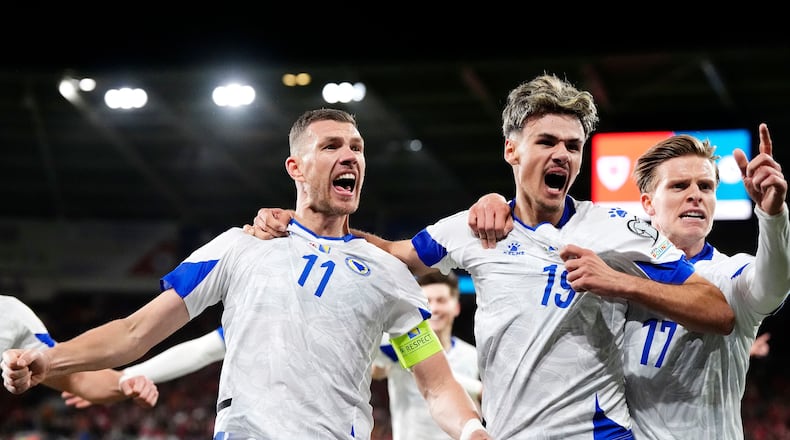 Bosnia and Herzegovina's Edin Dzeko, left, celebrates with team-mates after scoring their side's first goal during the World Cup playoff semifinal soccer match between Wales and Bosnia and Herzegovina in Cardiff, Wales, Thursday, March 26, 2026. (Nick Potts/PA via AP)