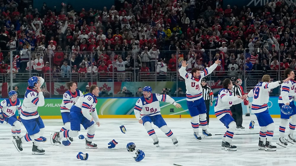 United States players celebrate after defeating Canada during a men's ice hockey gold medal game between Canada and the United States at the 2026 Winter Olympics, in Milan, Italy, Sunday, Feb. 22, 2026. (AP Photo/Petr David Josek)