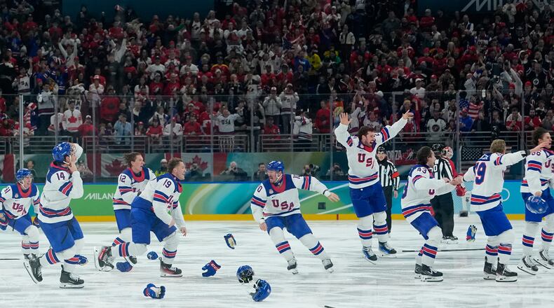 United States players celebrate after defeating Canada during a men's ice hockey gold medal game between Canada and the United States at the 2026 Winter Olympics, in Milan, Italy, Sunday, Feb. 22, 2026. (AP Photo/Petr David Josek)