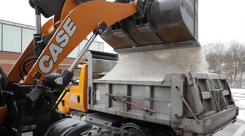 A City of Springfield salt truck is filled with salt Monday. BILL LACKEY/STAFF