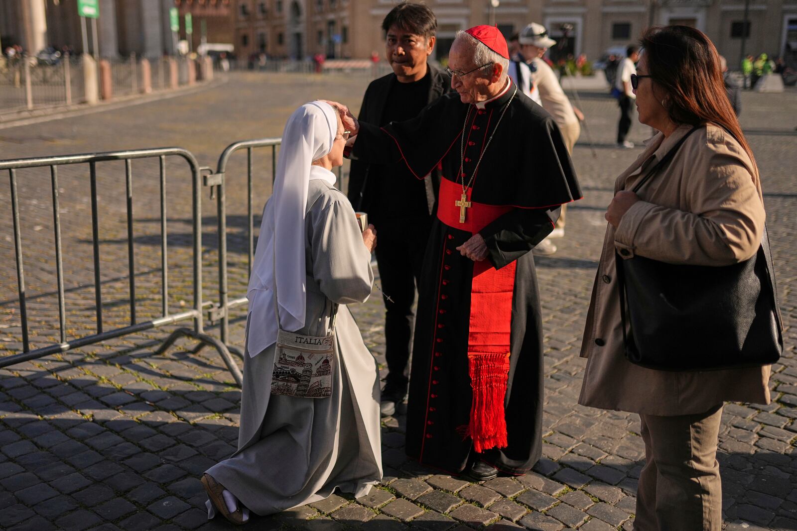 Cardinal Silvano Tomasi blesses a nun in St. Peter's Square at the Vatican, Tuesday, April 22, 2025. (AP Photo/Francisco Seco)